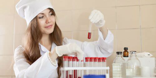 Лаборант держит пробирку с кровью Лаборант держит пробирку с кровью